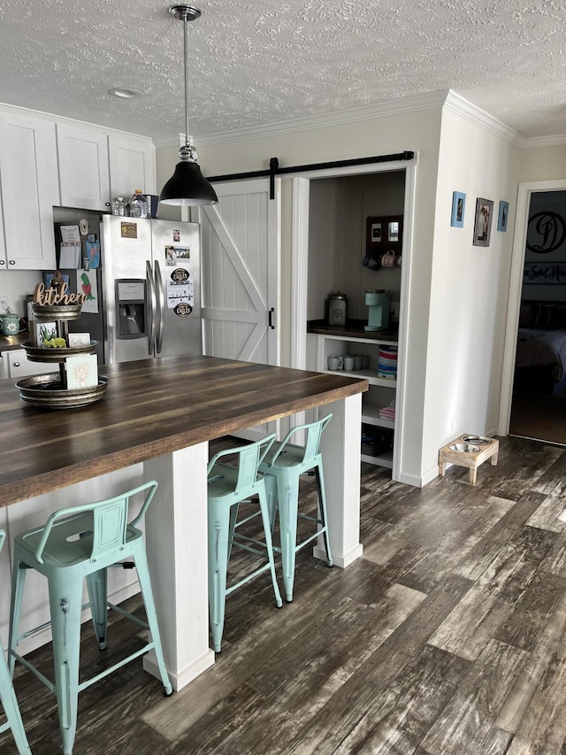 1148 Chapel View Ln, Goodview, VA 24095 - kitchen featuring wood counters, a barn door, stainless steel fridge with ice dispenser, a textured ceiling, and dark wood-style flooring