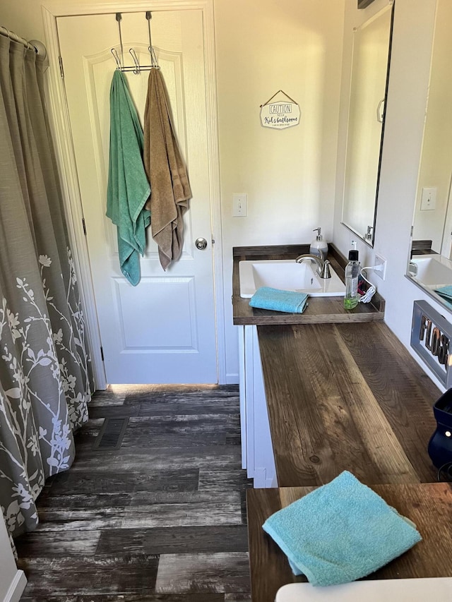 1148 Chapel View Ln, Goodview, VA 24095 - full bath with wood finished floors, vanity, and a shower with shower curtain