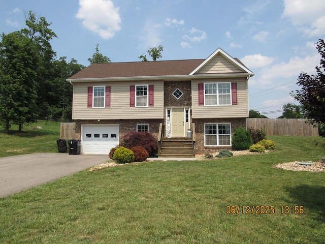 5605 Prunty Dr, Salem, VA 24153 - bi-level home featuring asphalt driveway, an attached garage, and brick siding