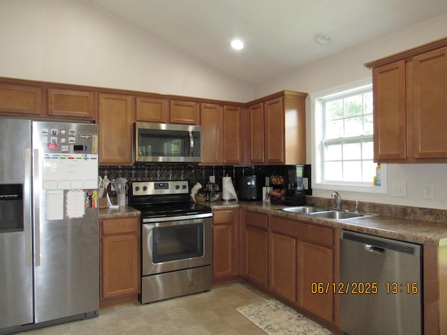 5605 Prunty Dr, Salem, VA 24153 - kitchen with stainless steel appliances, brown cabinets, tasteful backsplash, dark countertops, and lofted ceiling