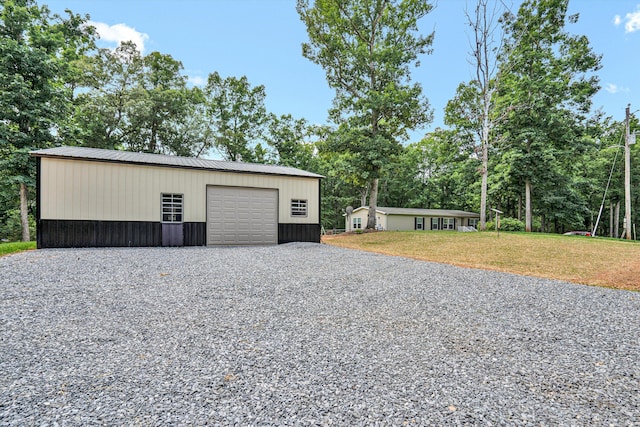 1060 Marble Creek Ct, Lynch Station, VA 24571 - garage with gravel driveway and view of wooded area