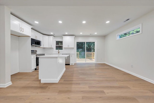 3713 Pinevale Rd, Roanoke, VA 24018 - kitchen with appliances with stainless steel finishes, white cabinetry, recessed lighting, light countertops, and light wood finished floors