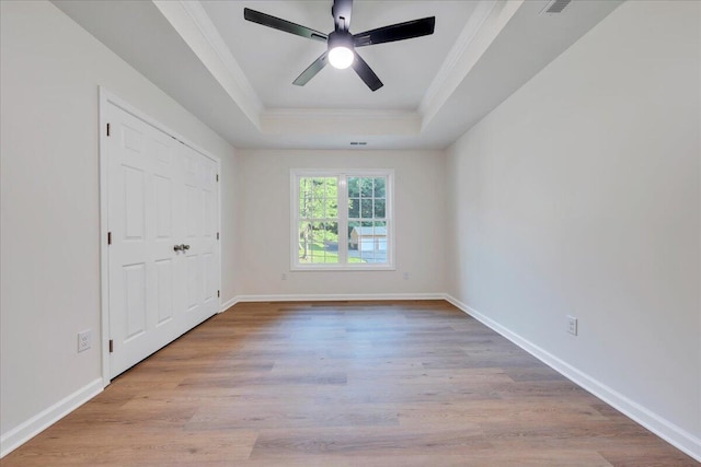 3713 Pinevale Rd, Roanoke, VA 24018 - unfurnished bedroom featuring a tray ceiling, ornamental molding, wood finished floors, and a ceiling fan