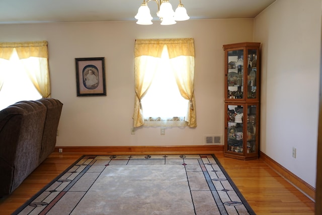 520 S Poplar St, Vinton, VA 24179 - dining space featuring a chandelier, wood finished floors, and plenty of natural light