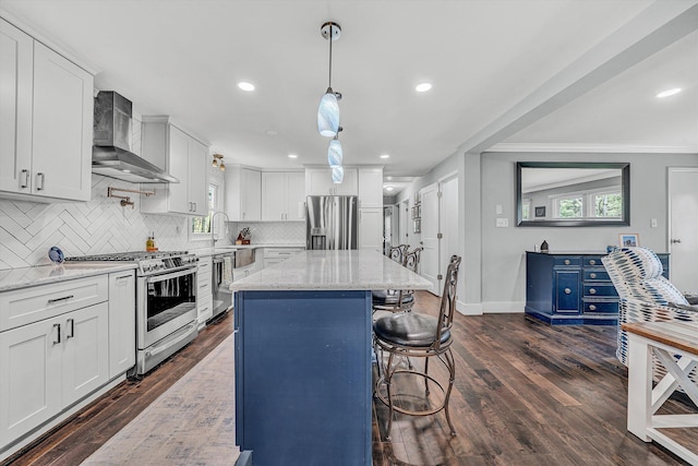 10610 Slings Gap Rd, Bent Mountain, VA 24059 - kitchen with stainless steel appliances, wall chimney range hood, decorative backsplash, white cabinets, and recessed lighting