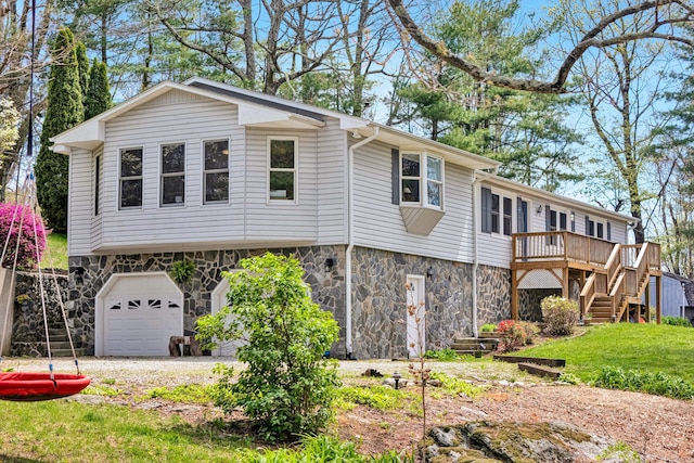 10610 Slings Gap Rd, Bent Mountain, VA 24059 - view of front of home featuring stone siding, stairway, an attached garage, a wooden deck, and driveway