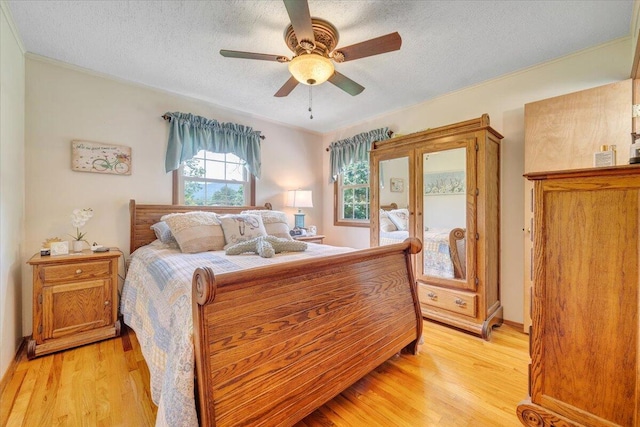 3203 Bradshaw Rd, Salem, VA 24153 - bedroom with light wood-type flooring, a textured ceiling, ceiling fan, and crown molding