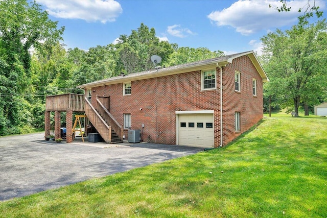 3203 Bradshaw Rd, Salem, VA 24153 - back of property featuring asphalt driveway, stairs, a yard, brick siding, and an attached garage