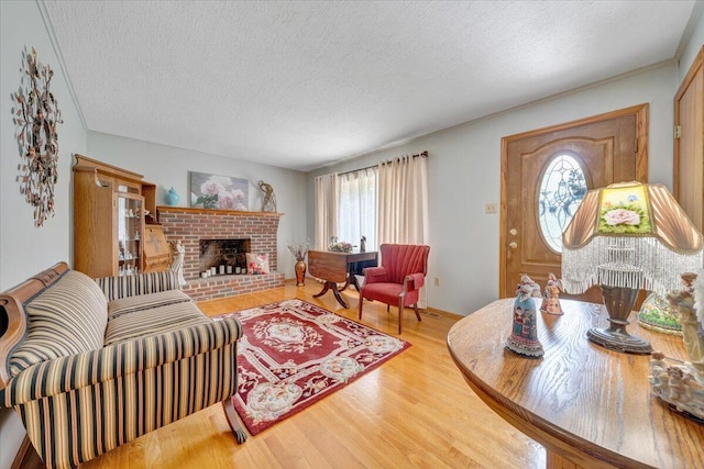 3203 Bradshaw Rd, Salem, VA 24153 - living room with a textured ceiling, wood finished floors, and a brick fireplace