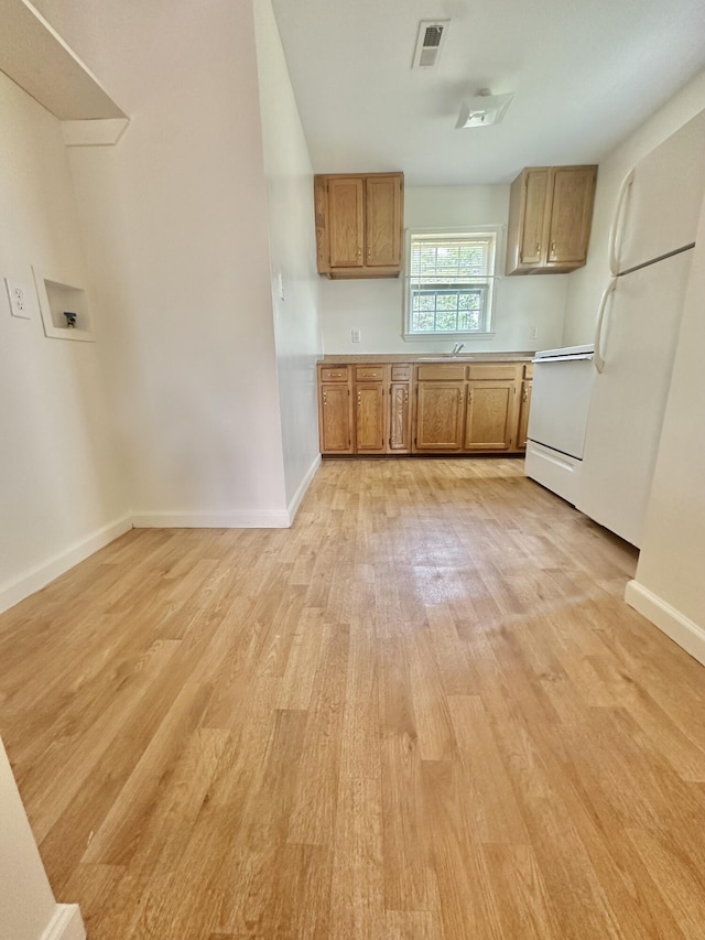 418 Marshall Ave, New Castle, VA 24127 - kitchen with light wood-style floors, brown cabinetry, stove, and light countertops