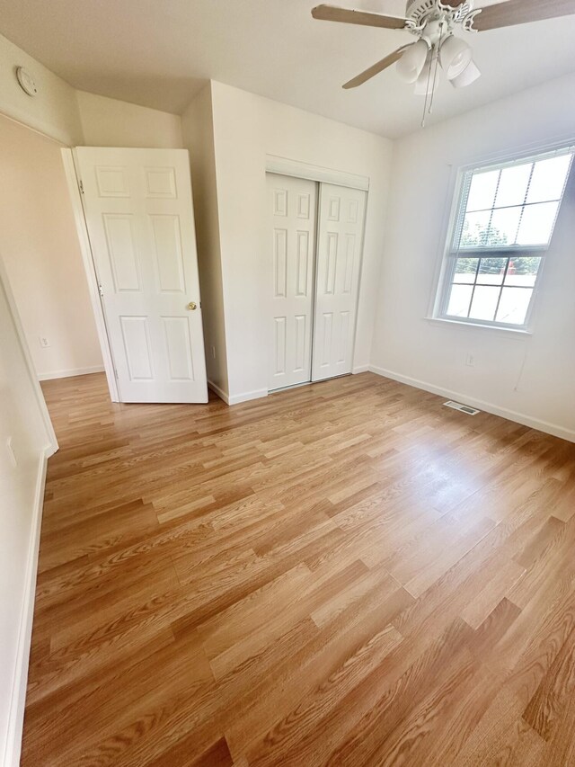 418 Marshall Ave, New Castle, VA 24127 - unfurnished bedroom featuring light wood-style floors, a closet, and ceiling fan
