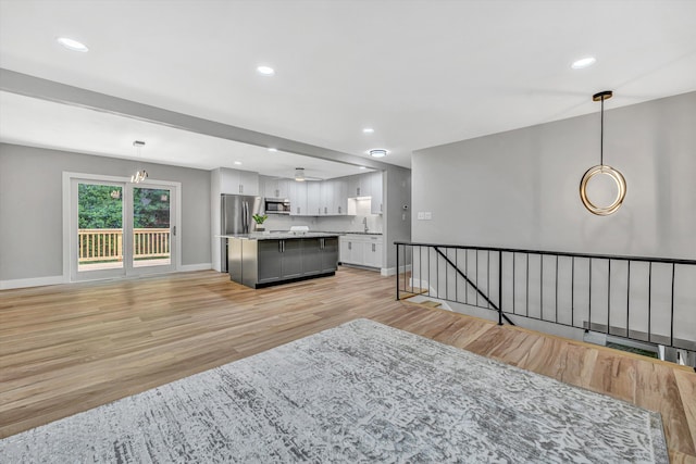 3631 Bower Rd, Roanoke, VA 24018 - kitchen with appliances with stainless steel finishes, light wood finished floors, a center island, pendant lighting, and open floor plan