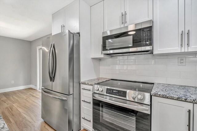 3631 Bower Rd, Roanoke, VA 24018 - kitchen with stainless steel appliances, white cabinetry, backsplash, and light stone countertops