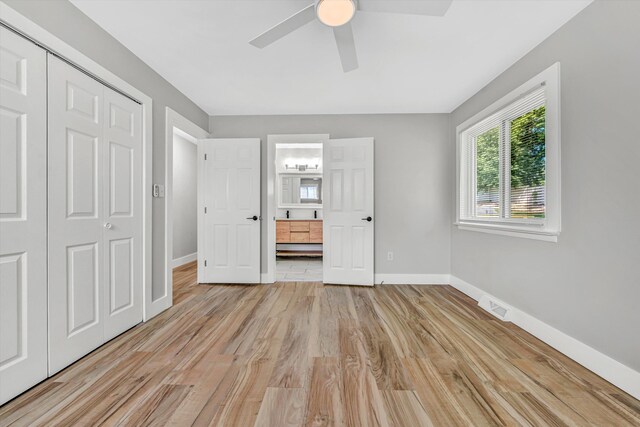 3631 Bower Rd, Roanoke, VA 24018 - unfurnished bedroom featuring light wood-style floors, a baseboard heating unit, connected bathroom, ceiling fan, and a closet