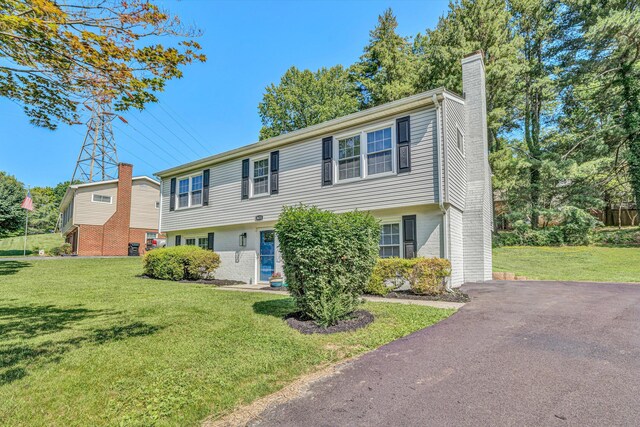 3631 Bower Rd, Roanoke, VA 24018 - colonial-style house featuring a chimney, a front lawn, and brick siding