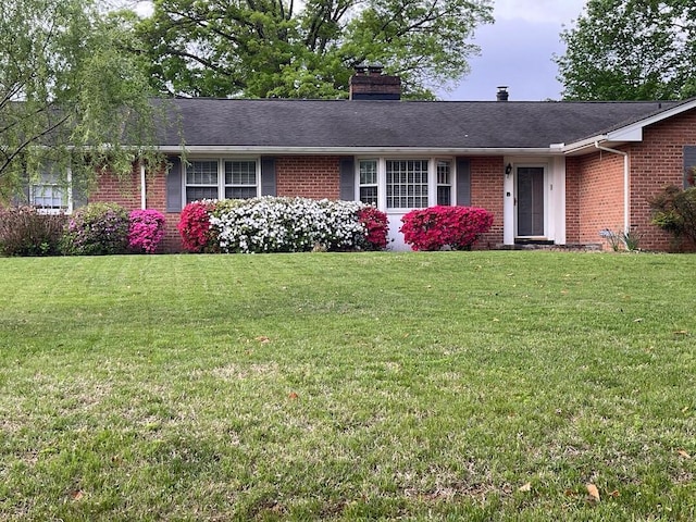 3210 Orchard Hill Rd SW, Roanoke, VA 24018 - ranch-style house with brick siding, a front lawn, a chimney, and roof with shingles