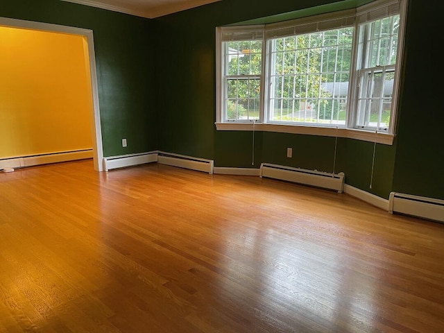 3210 Orchard Hill Rd SW, Roanoke, VA 24018 - spare room featuring a baseboard radiator, wood finished floors, and ornamental molding