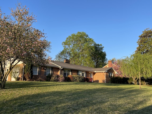 3210 Orchard Hill Rd SW, Roanoke, VA 24018 - single story home with brick siding, a front yard, and a chimney