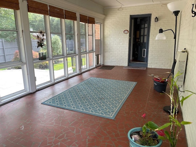 3210 Orchard Hill Rd SW, Roanoke, VA 24018 - sunroom featuring brick wall and crown molding