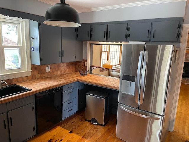 3210 Orchard Hill Rd SW, Roanoke, VA 24018 - kitchen with stainless steel fridge with ice dispenser, dishwasher, light wood finished floors, ornamental molding, and tile counters