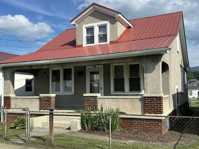 115 E Walnut St, Covington, VA 24426 - view of front of house featuring covered porch, stucco siding, a metal roof, and brick siding