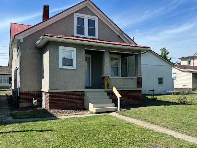 115 E Walnut St, Covington, VA 24426 - view of front of house featuring stucco siding, a metal roof, brick siding, and a chimney