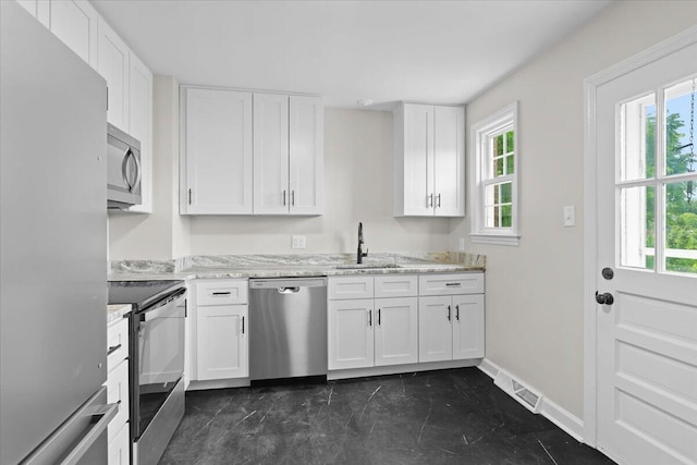 21 Upland Dr, Salem, VA 24153 - kitchen with stainless steel appliances, plenty of natural light, white cabinetry, and light stone counters