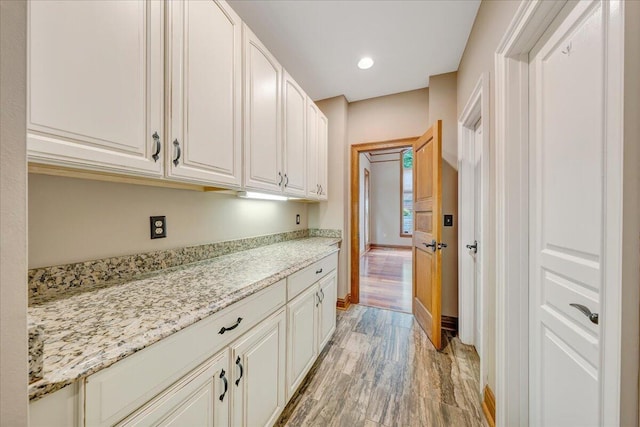 223 Moonriver Ln, Moneta, VA 24121 - kitchen with light wood-style floors, white cabinets, light stone counters, and recessed lighting
