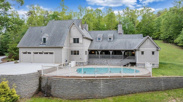 223 Moonriver Ln, Moneta, VA 24121 - back of house featuring driveway, an attached garage, a yard, stairs, and a chimney