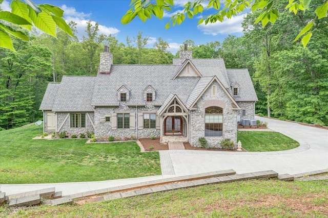 223 Moonriver Ln, Moneta, VA 24121 - view of front facade featuring stone siding, a chimney, and a front yard