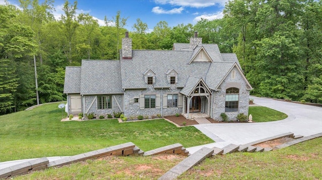 223 Moonriver Ln, Moneta, VA 24121 - tudor-style house with stone siding, a front yard, and a chimney