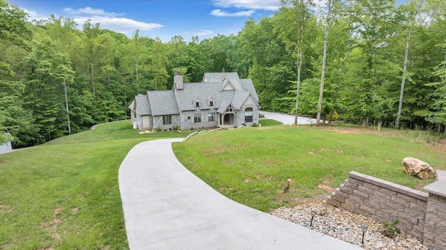 223 Moonriver Ln, Moneta, VA 24121 - view of front of home with a forest view, a chimney, and a front lawn