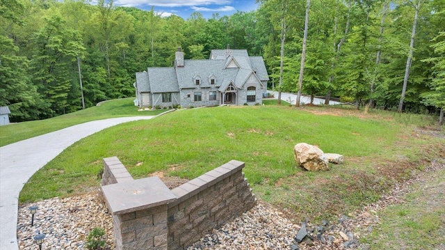 223 Moonriver Ln, Moneta, VA 24121 - view of front of house featuring a view of trees, a chimney, and a front yard