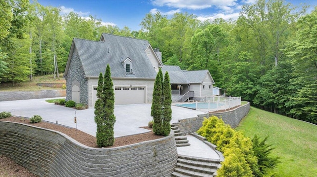 223 Moonriver Ln, Moneta, VA 24121 - view of side of property featuring stairs, concrete driveway, a wooded view, a yard, and an attached garage
