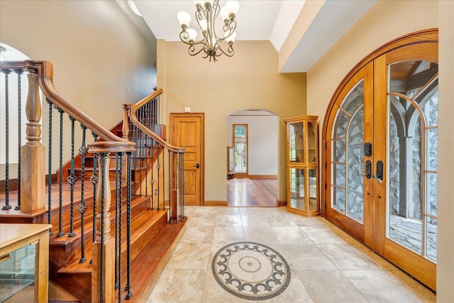 223 Moonriver Ln, Moneta, VA 24121 - tiled entryway with arched walkways, french doors, a chandelier, stairs, and a high ceiling