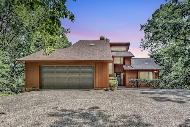 7102 Crown Rd, Roanoke, VA 24018 - mid-century modern home featuring asphalt driveway, a garage, a chimney, and a shingled roof