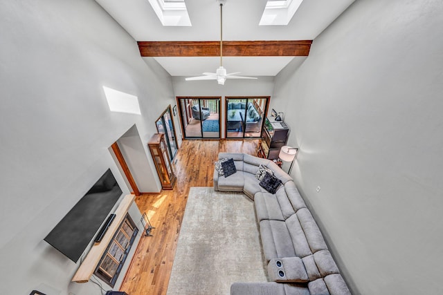 7102 Crown Rd, Roanoke, VA 24018 - living room with a skylight, light wood finished floors, beam ceiling, and ceiling fan