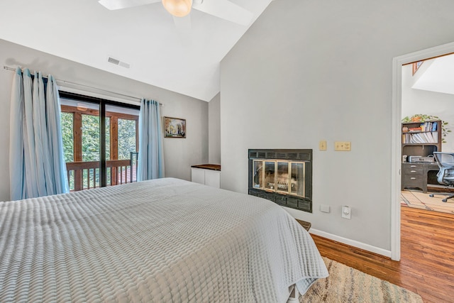 7102 Crown Rd, Roanoke, VA 24018 - bedroom with access to outside, wood finished floors, a glass covered fireplace, high vaulted ceiling, and a ceiling fan