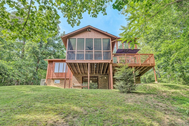 7102 Crown Rd, Roanoke, VA 24018 - rear view of house featuring a sunroom, a lawn, a deck, and brick siding