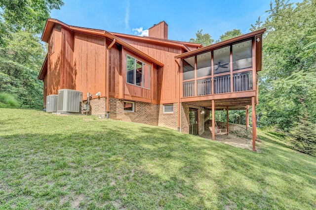 7102 Crown Rd, Roanoke, VA 24018 - rear view of house featuring a sunroom, a chimney, a yard, and ceiling fan