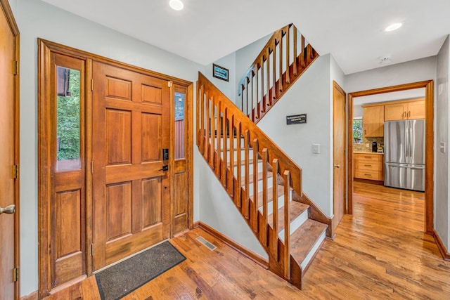 7102 Crown Rd, Roanoke, VA 24018 - foyer entrance with light wood finished floors, stairs, recessed lighting, and plenty of natural light