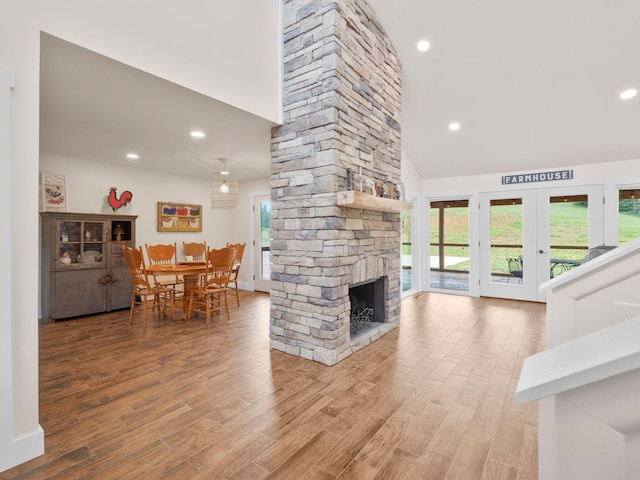 6000 Ferrum Mountain Rd, Callaway, VA 24067 - living room featuring a fireplace, wood finished floors, french doors, a high ceiling, and recessed lighting