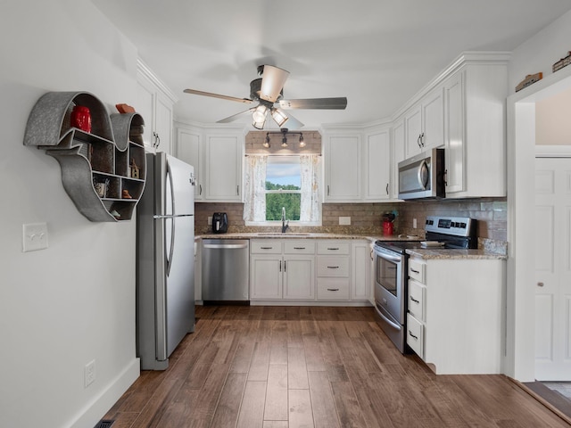 6000 Ferrum Mountain Rd, Callaway, VA 24067 - kitchen featuring stainless steel appliances, white cabinets, ceiling fan, tasteful backsplash, and dark wood-style flooring