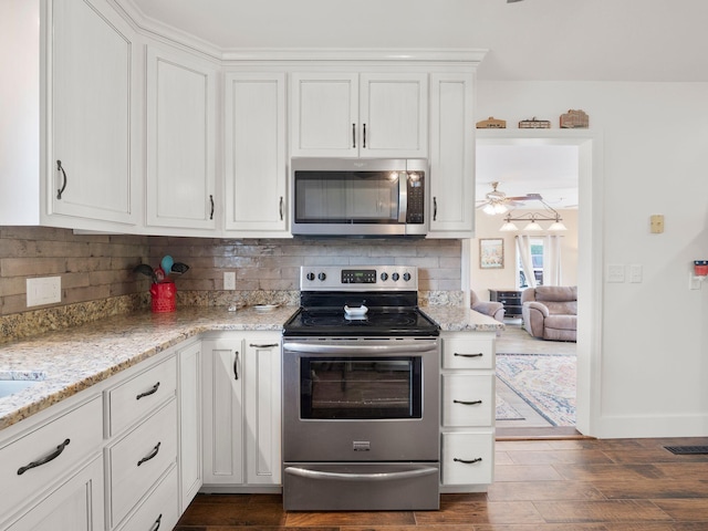 6000 Ferrum Mountain Rd, Callaway, VA 24067 - kitchen featuring appliances with stainless steel finishes, tasteful backsplash, white cabinets, and light stone counters