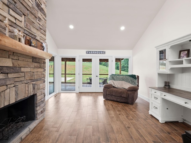 6000 Ferrum Mountain Rd, Callaway, VA 24067 - living room featuring french doors, high vaulted ceiling, dark wood-type flooring, a fireplace, and recessed lighting