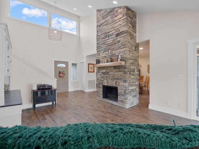 6000 Ferrum Mountain Rd, Callaway, VA 24067 - living area with a towering ceiling, wood finished floors, and a stone fireplace