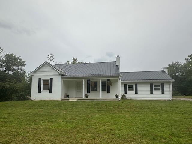 2327 Horsepasture Price Rd, Ridgeway, VA 24148 - rear view of property featuring a chimney, a yard, and a metal roof