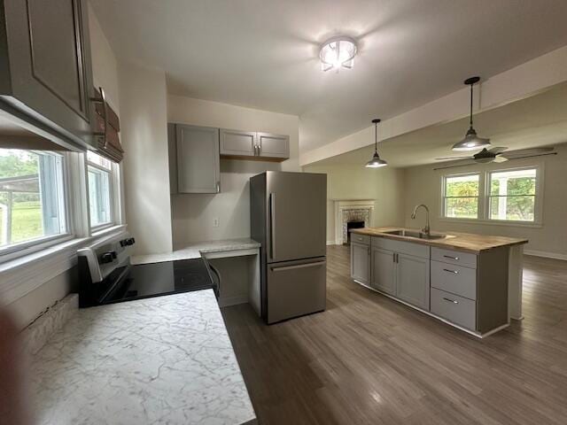 2327 Horsepasture Price Rd, Ridgeway, VA 24148 - kitchen with stainless steel appliances, gray cabinetry, a fireplace, and dark wood finished floors