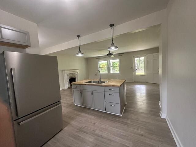 2327 Horsepasture Price Rd, Ridgeway, VA 24148 - kitchen featuring freestanding refrigerator, open floor plan, ceiling fan, a fireplace, and dark wood finished floors