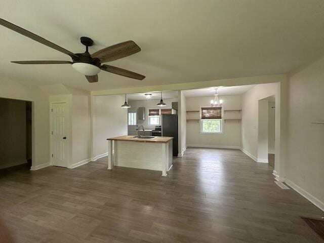 2327 Horsepasture Price Rd, Ridgeway, VA 24148 - kitchen featuring dark wood-type flooring, a center island with sink, a ceiling fan, a chandelier, and open floor plan